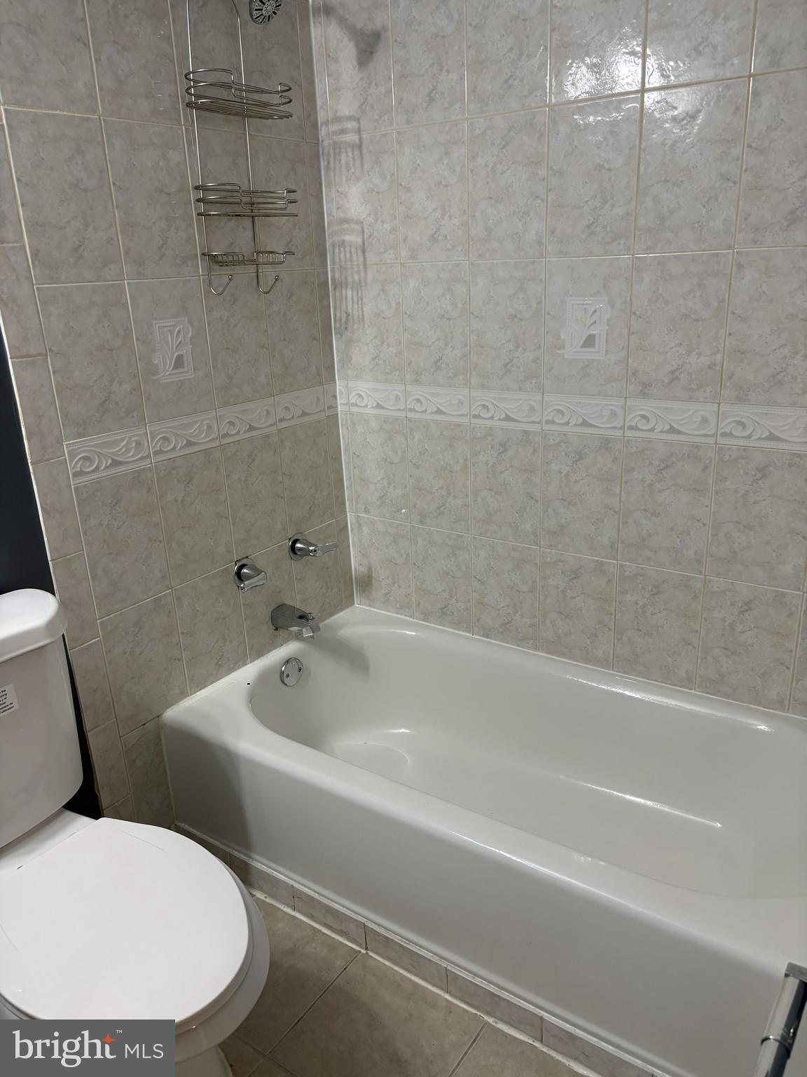 13242 Stravinsky Terrace Silver Spring, MD 20904 - Photo 6 of 11 a white bath tub sitting next to a toilet