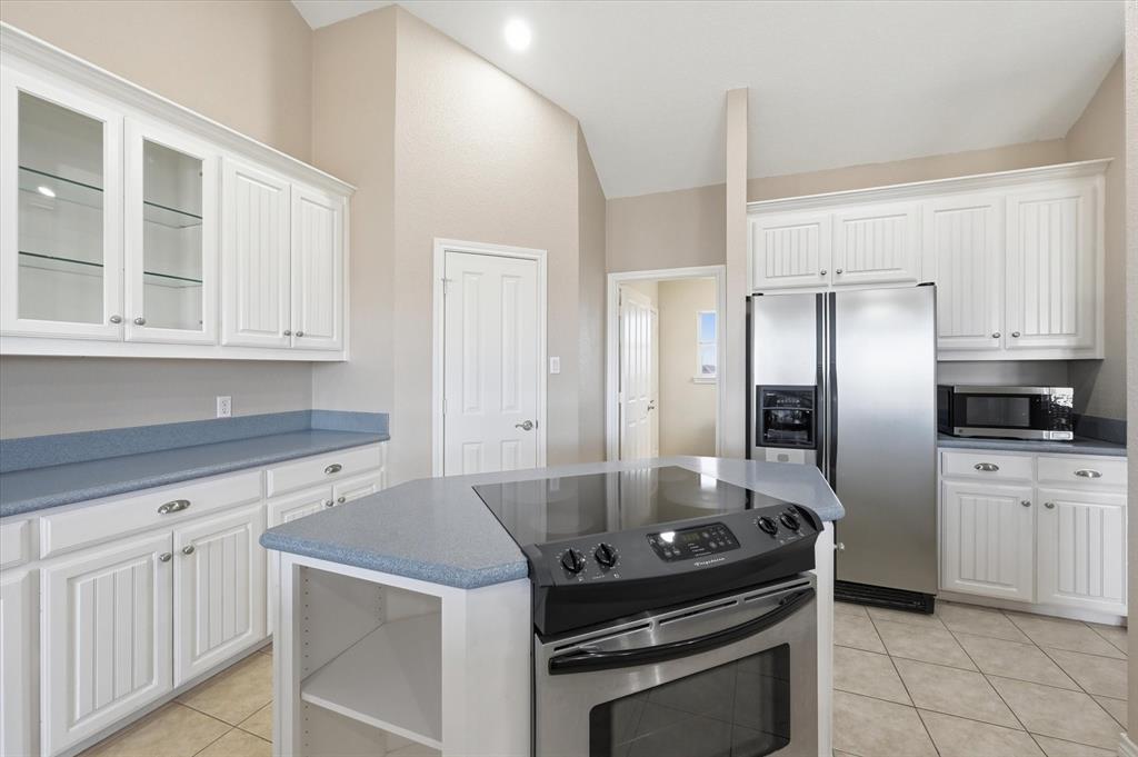 1616 Nash-Howard Road Waxahachie, TX 75165 - Photo 14 of 36 a kitchen with granite countertop a stove sink and refrigerator