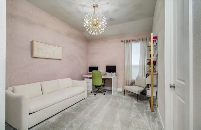 a living room with furniture and a chandelier