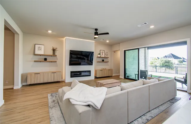 a living room with furniture flat screen tv and a fireplace