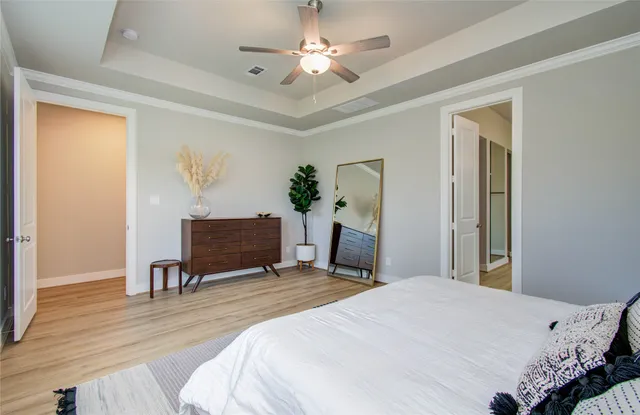 a bedroom with a bed and a chandelier
