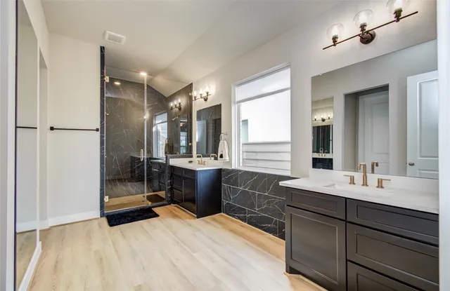 a bathroom with a double vanity sink mirror and double