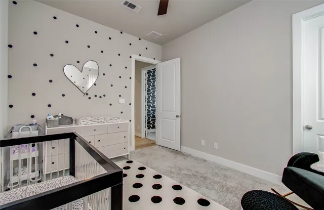 a bedroom with a bed and a dresser