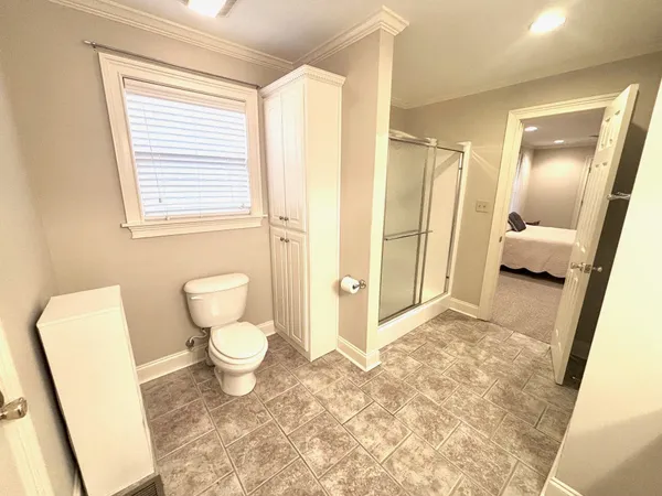 a bathroom with a toilet sink and a mirror