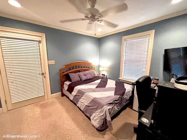 a bedroom with bed and windows