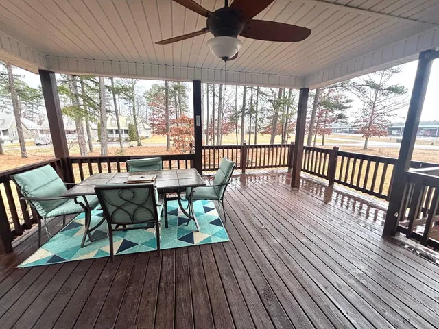 a view of a patio with a table chairs and wooden floor