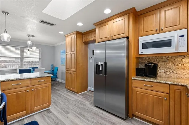 a kitchen with stainless steel appliances a refrigerator stove and sink