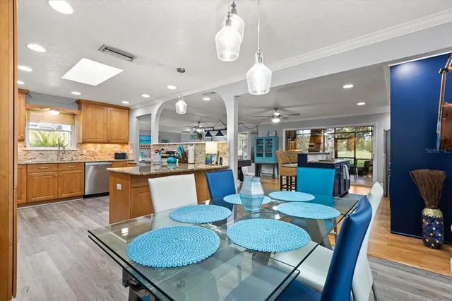 a dining room with kitchen view and kitchen