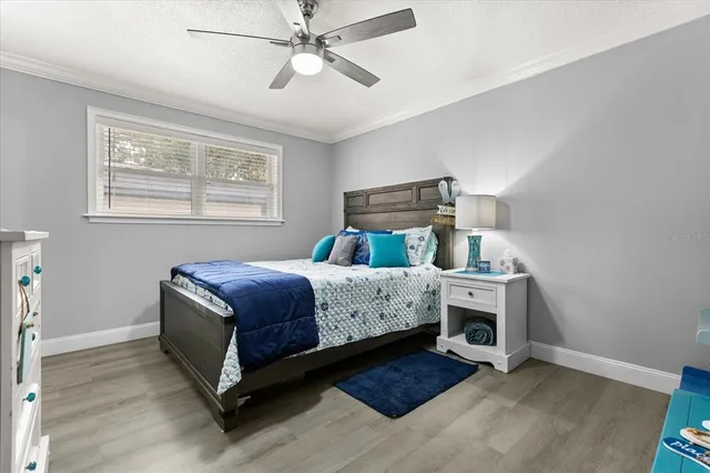 a bedroom with a large bed and a desk