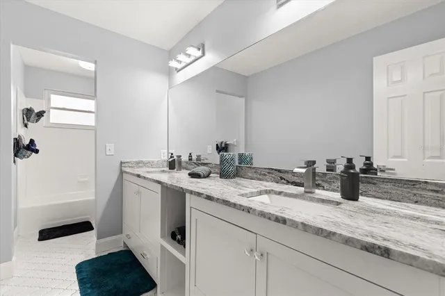 a bathroom with a shower a toilet and a tub