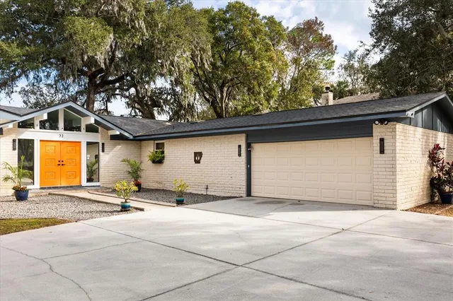 a living room with furniture a dining table and chairs with wooden floor