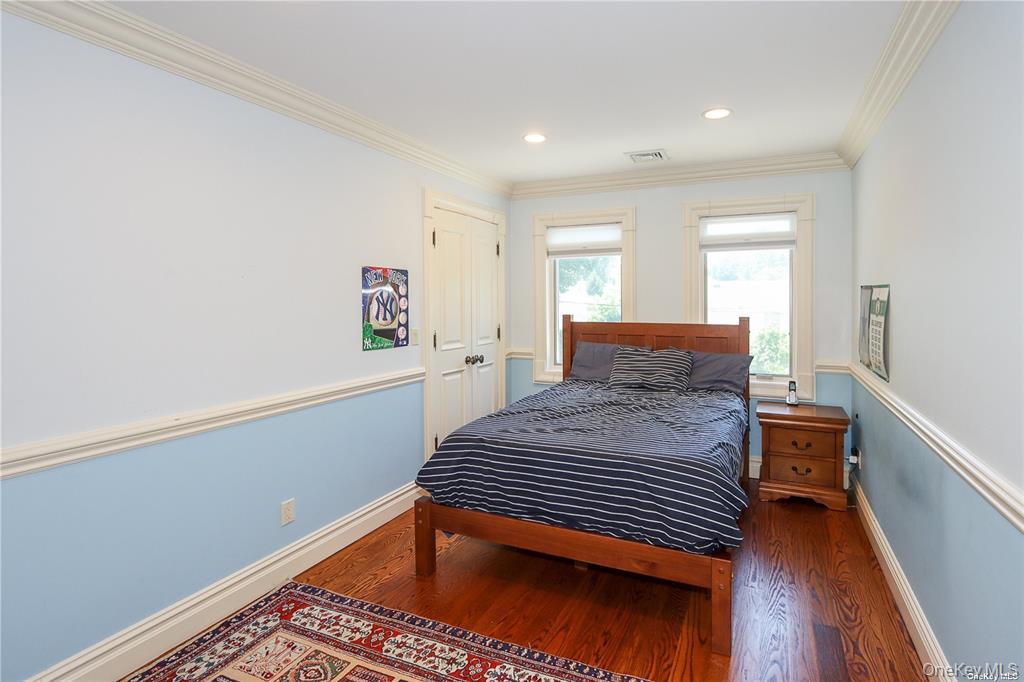 24 Steamboat Road Great Neck, NY 11024 - Photo 20 of 28 Bedroom featuring crown molding, wood finished floors, and recessed lighting