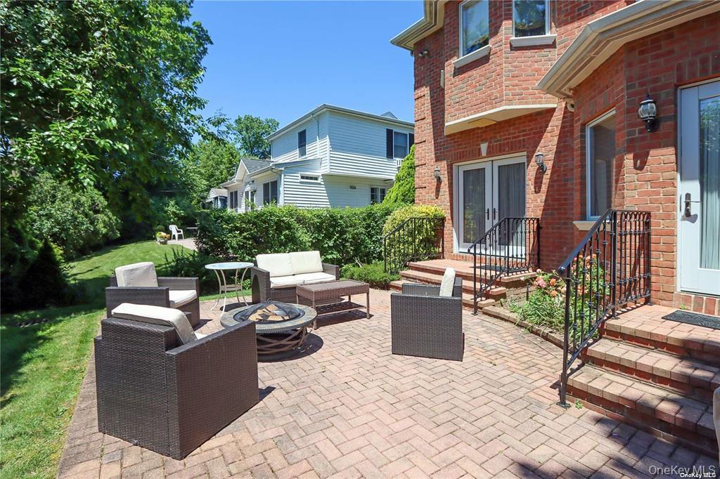 24 Steamboat Road Great Neck, NY 11024 - Photo 28 of 28 View of patio with an outdoor living space with a fire pit