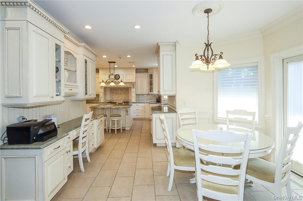 24 Steamboat Road Great Neck, NY 11024 - Photo 8 of 28 Dining area featuring light tile patterned floors, recessed lighting, a chandelier, and crown molding