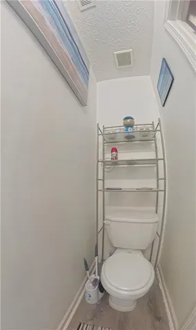 a bathroom with a toilet and a sink