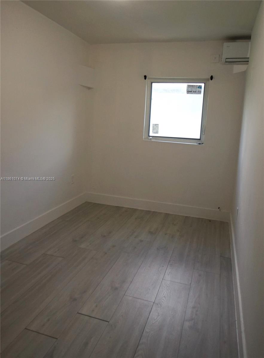584 Northwest 65th Street, Unit 11 Miami, FL 33150 - Photo 6 of 8 an empty room with a window