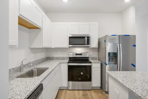a kitchen with a sink stove and refrigerator