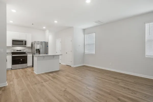 a view of kitchen with microwave and cabinets