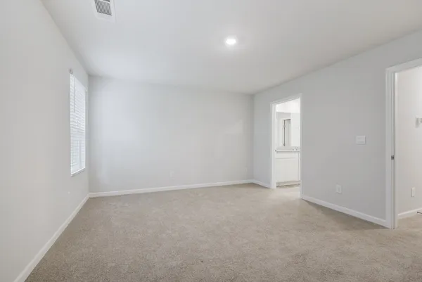 a view of an empty room and a window