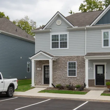 a front view of a house with a garden and garage