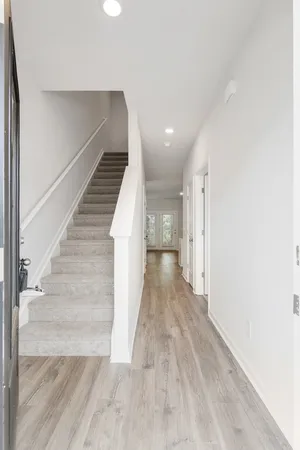 a view of entryway and hall with wooden floor