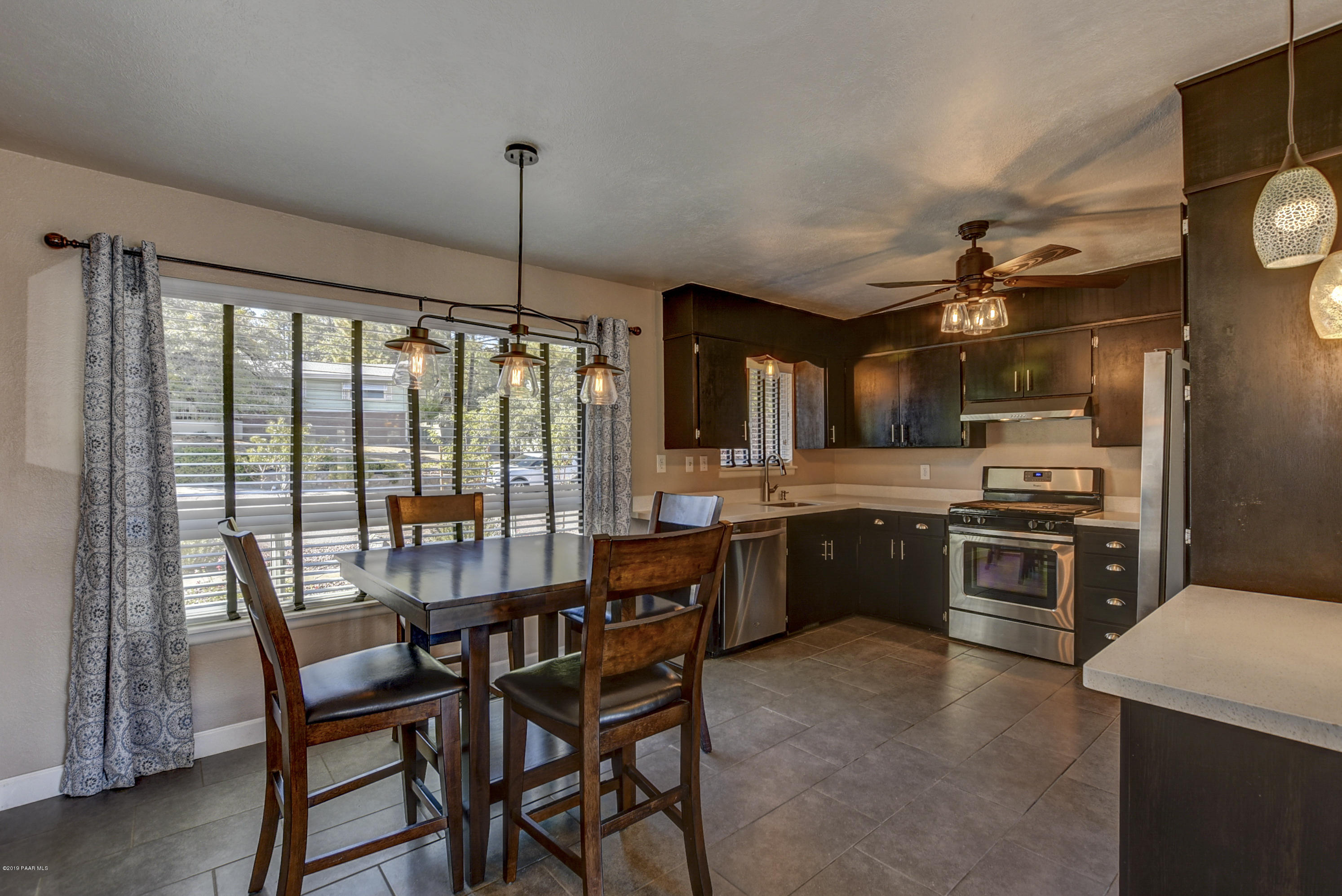 439 Canyon Springs Road Prescott, AZ 86303 - Photo 11 of 37 a kitchen with a stove a sink and a refrigerator