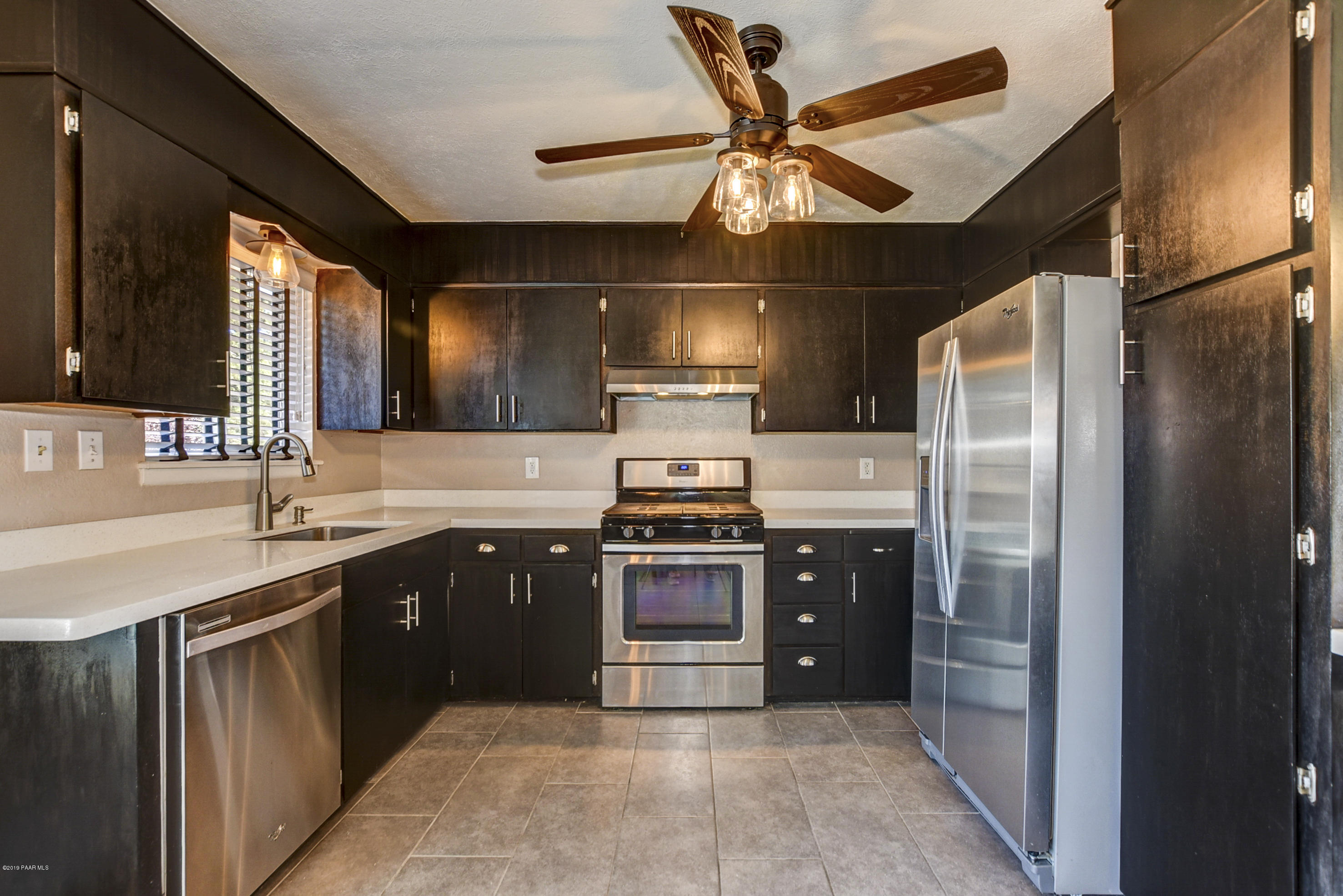 439 Canyon Springs Road Prescott, AZ 86303 - Photo 12 of 37 a kitchen with stainless steel appliances granite countertop a sink and a refrigerator