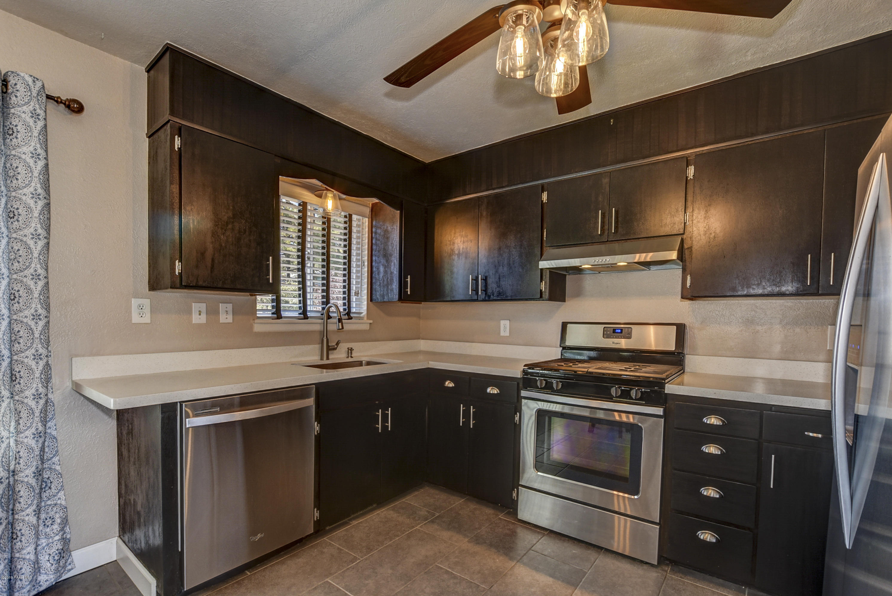 439 Canyon Springs Road Prescott, AZ 86303 - Photo 13 of 37 a kitchen with stainless steel appliances granite countertop a sink and a stove