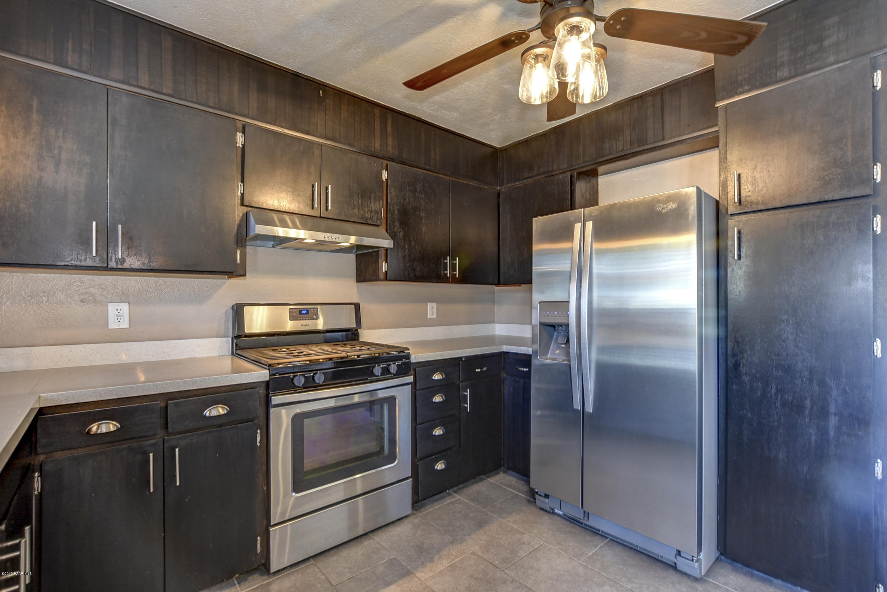 439 Canyon Springs Road Prescott, AZ 86303 - Photo 14 of 37 a kitchen with stainless steel appliances granite countertop a stove a refrigerator and a refrigerator
