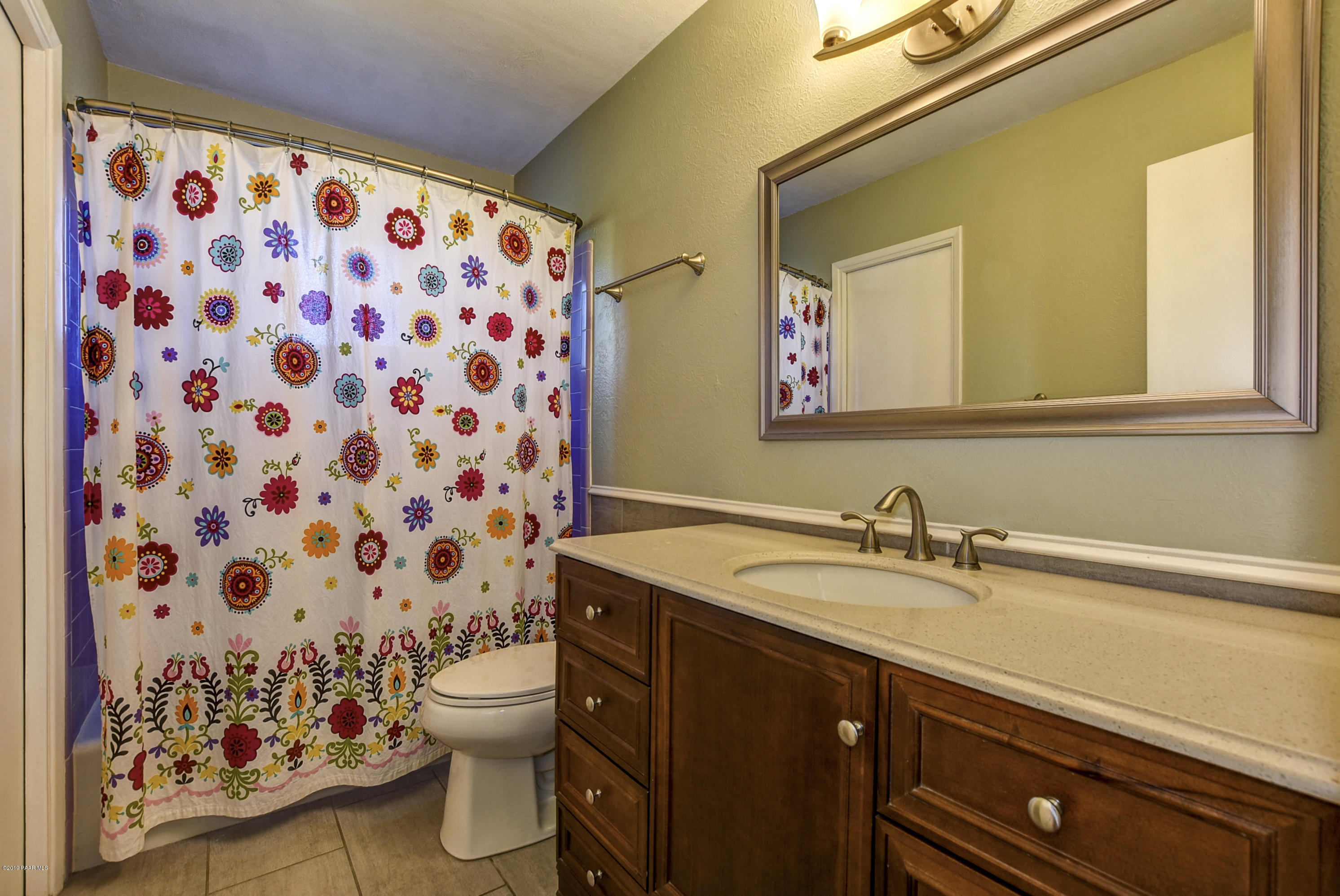 439 Canyon Springs Road Prescott, AZ 86303 - Photo 20 of 37 a bathroom with a sink a toilet and a mirror