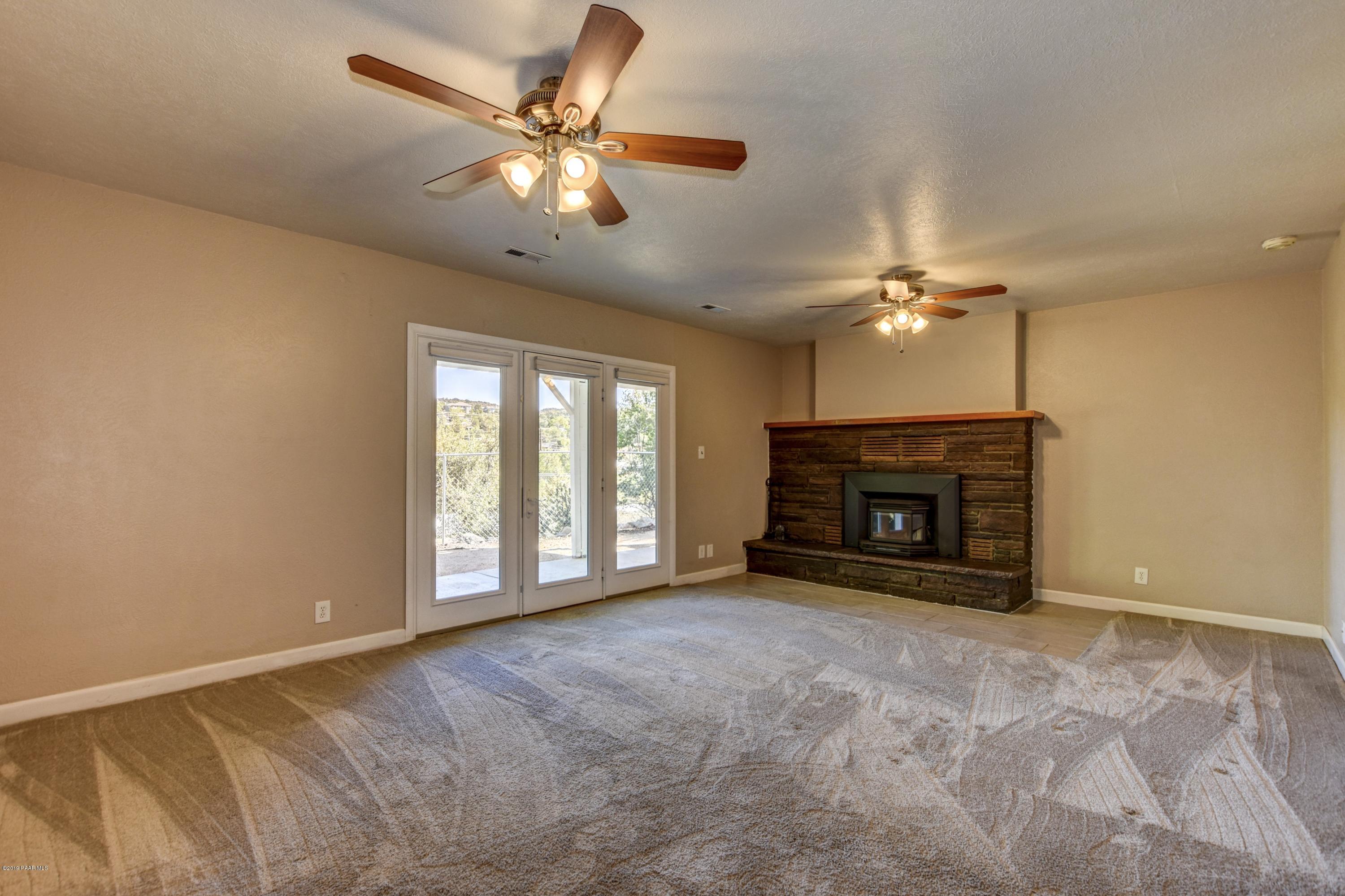 439 Canyon Springs Road Prescott, AZ 86303 - Photo 23 of 37 an empty room with windows and fireplace