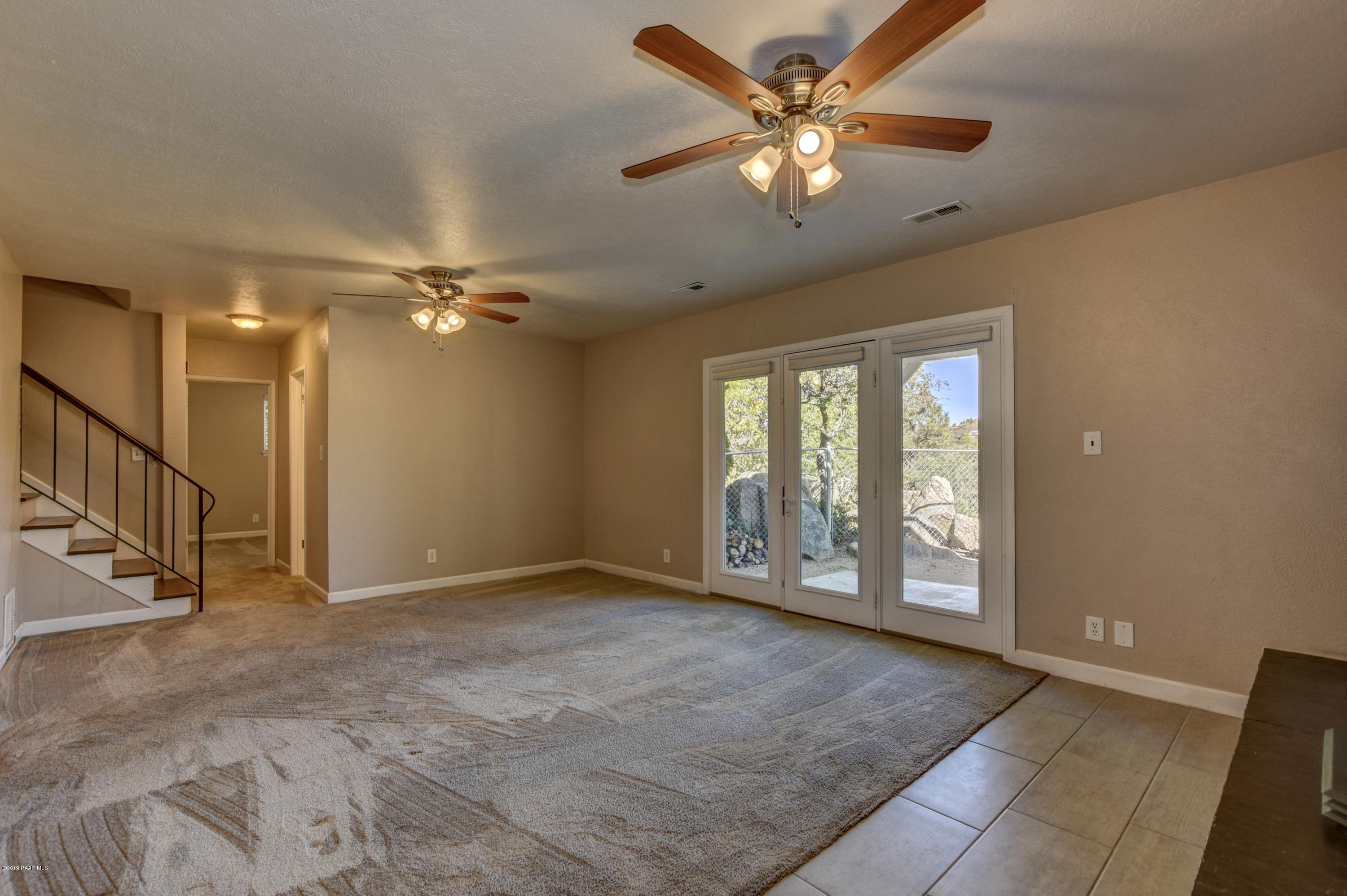 439 Canyon Springs Road Prescott, AZ 86303 - Photo 25 of 37 an empty room with chandelier fan and windows