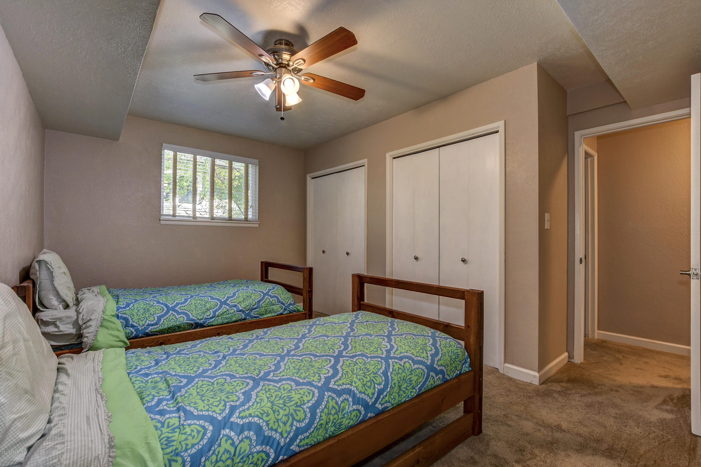 439 Canyon Springs Road Prescott, AZ 86303 - Photo 27 of 37 a bedroom with a bed and two windows