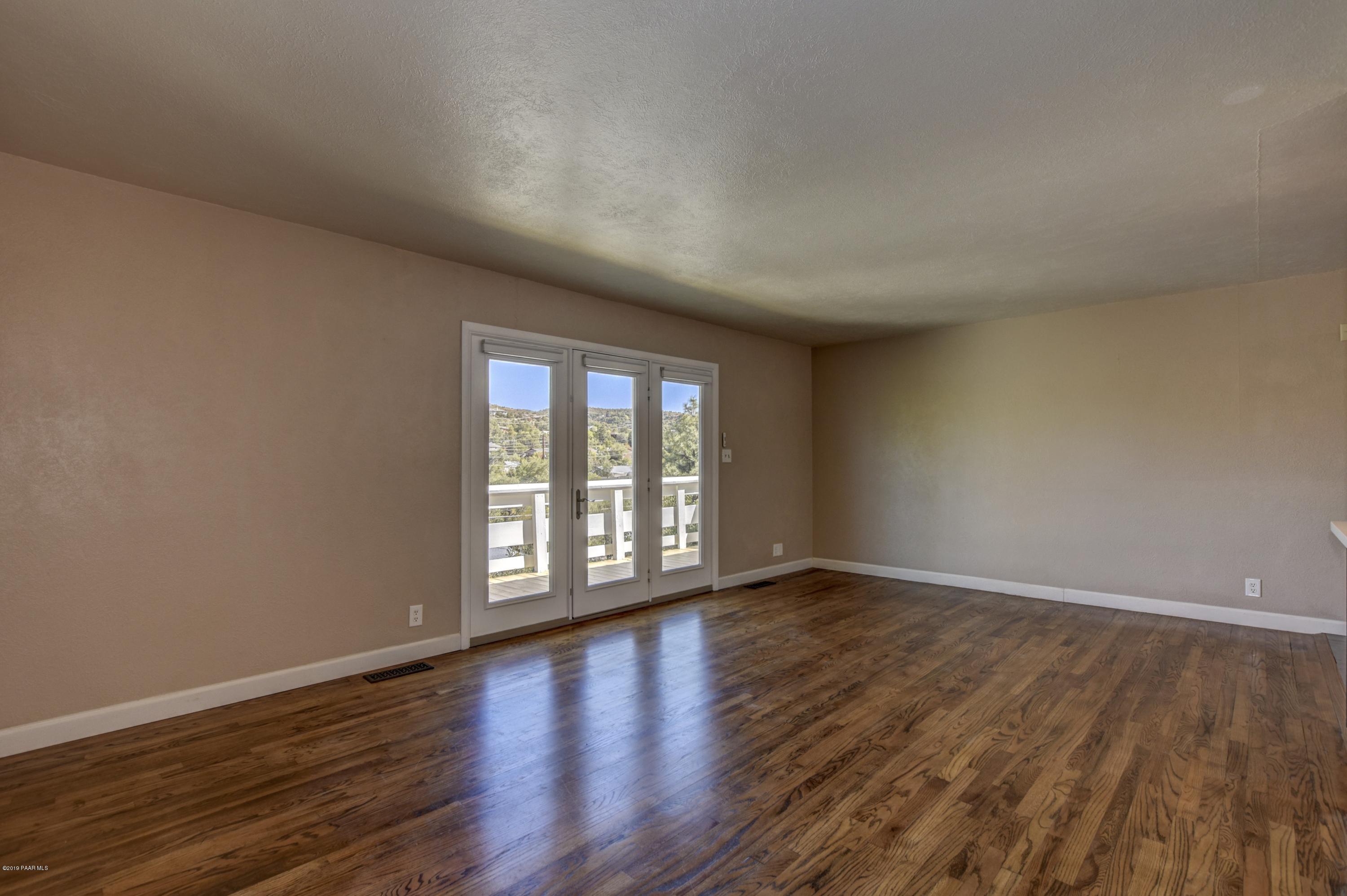 439 Canyon Springs Road Prescott, AZ 86303 - Photo 5 of 37 a view of an empty room with wooden floor and a window
