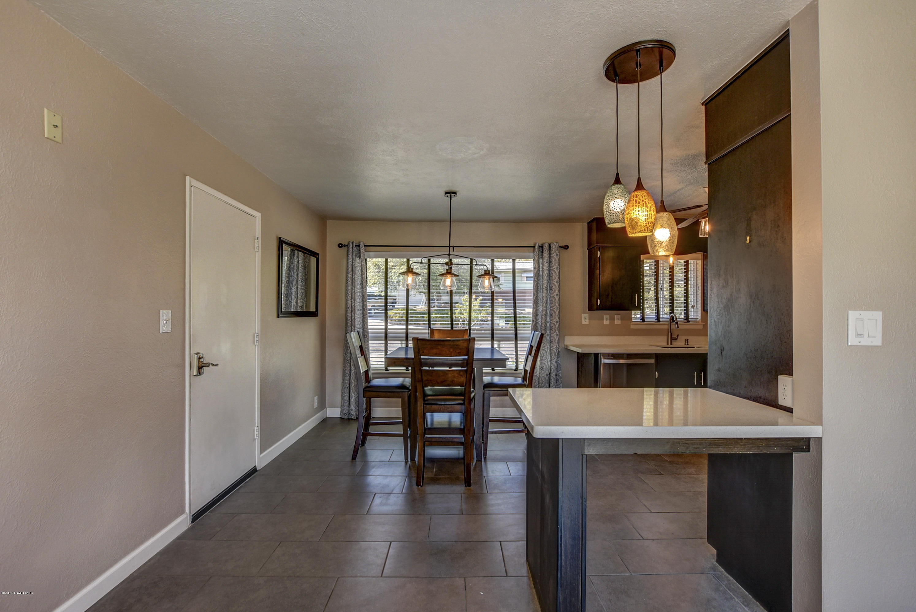 439 Canyon Springs Road Prescott, AZ 86303 - Photo 10 of 37 a view of a dining room and livingroom with furniture wooden floor a chandelier