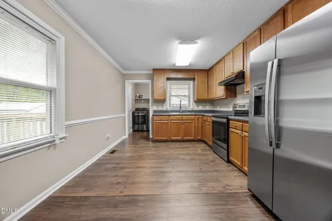 a kitchen with stainless steel appliances kitchen island granite countertop a sink and cabinets