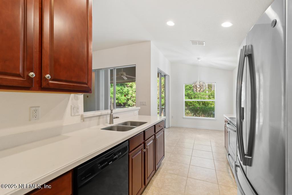 9080 Sweet Tree Trail Jacksonville, FL 32256 - Photo 11 of 44 a kitchen with stainless steel appliances a sink stove and a refrigerator