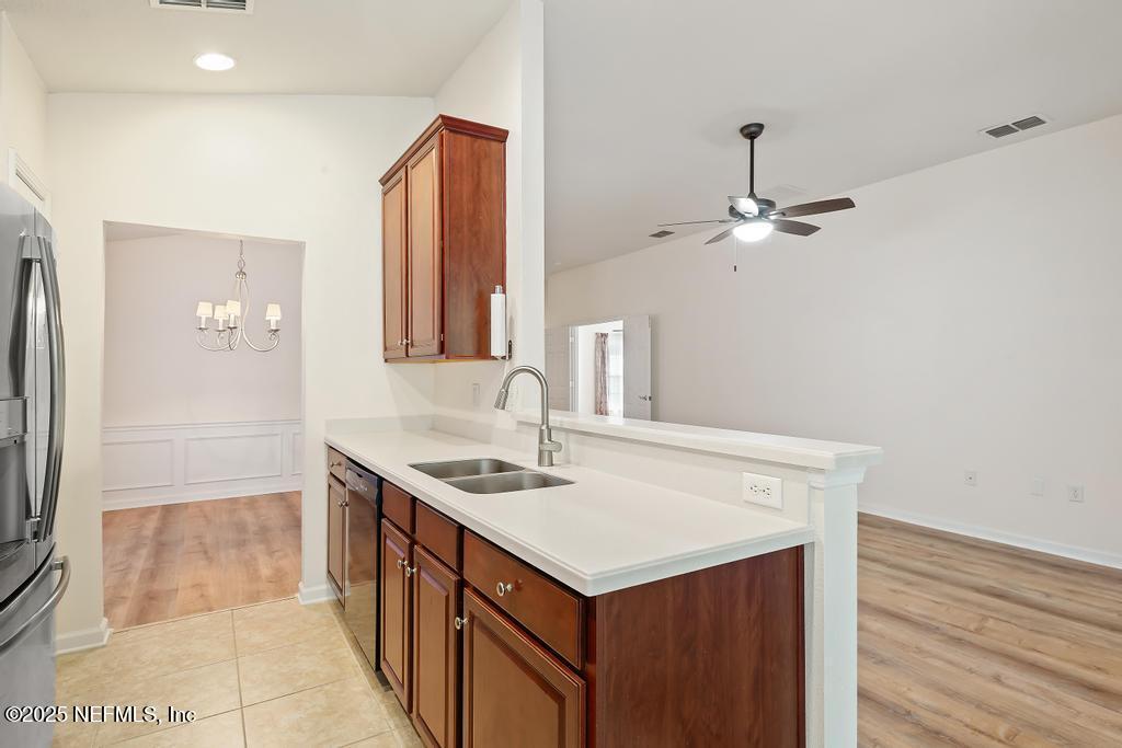 9080 Sweet Tree Trail Jacksonville, FL 32256 - Photo 12 of 44 a kitchen with a sink cabinets and wooden floor