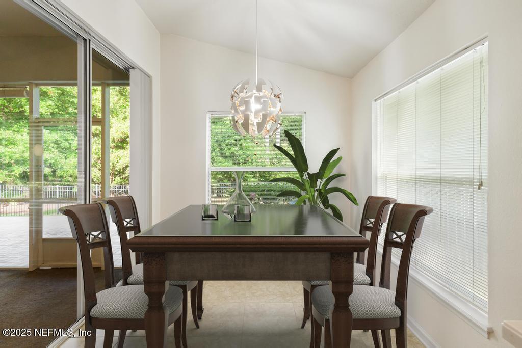 9080 Sweet Tree Trail Jacksonville, FL 32256 - Photo 13 of 44 a view of a dining room with furniture window and outside view
