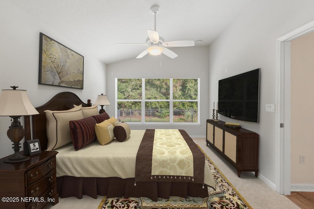 9080 Sweet Tree Trail Jacksonville, FL 32256 - Photo 15 of 44 a bedroom with furniture and a flat screen tv
