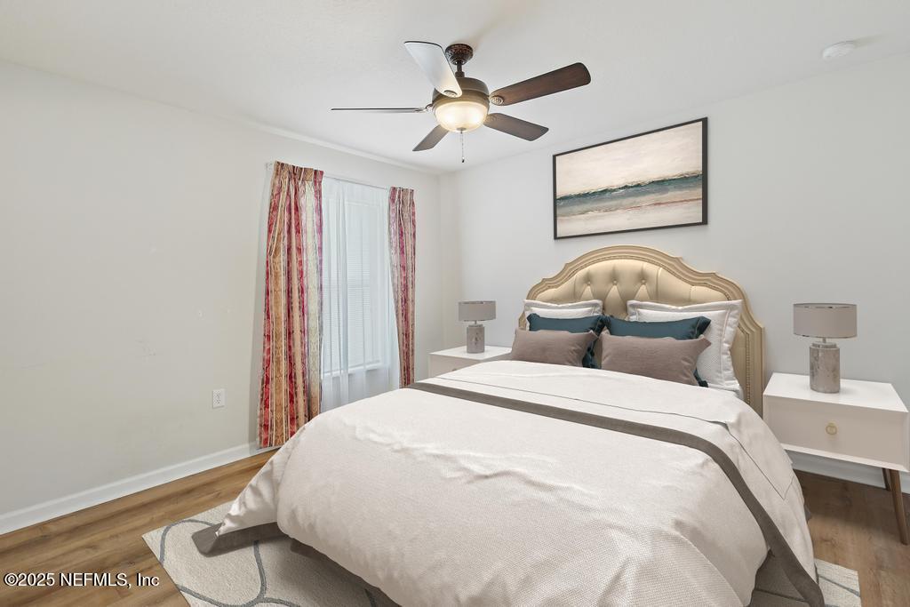 9080 Sweet Tree Trail Jacksonville, FL 32256 - Photo 24 of 44 a bedroom with a bed and a chandelier