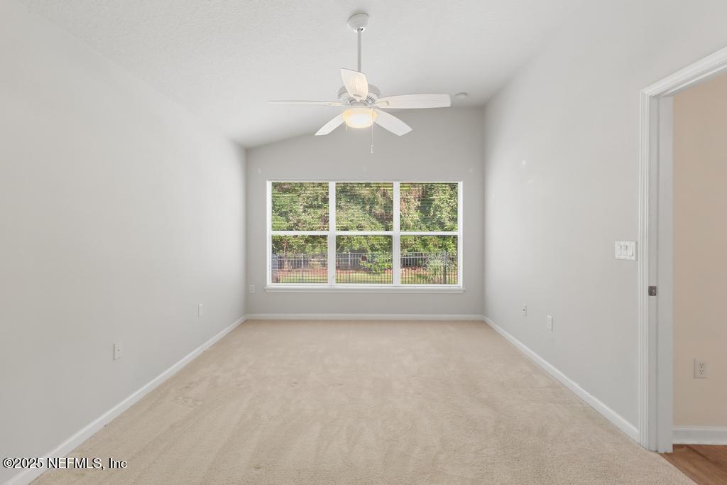 9080 Sweet Tree Trail Jacksonville, FL 32256 - Photo 34 of 44 an empty room with a window and a fan