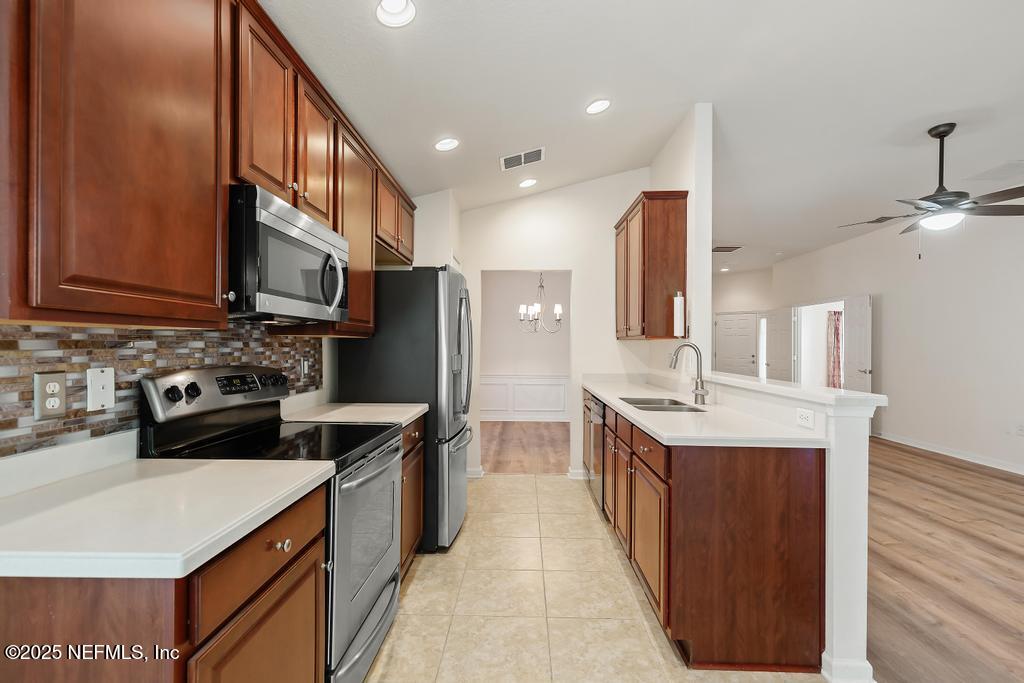 9080 Sweet Tree Trail Jacksonville, FL 32256 - Photo 7 of 44 a kitchen with stainless steel appliances a sink stove and refrigerator