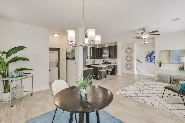 a living room with kitchen island furniture and a chandelier