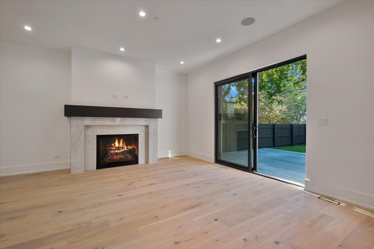 849 Sheridan Road Wilmette, IL 60091 - Photo 18 of 73 a view of an empty room with a fireplace and a window