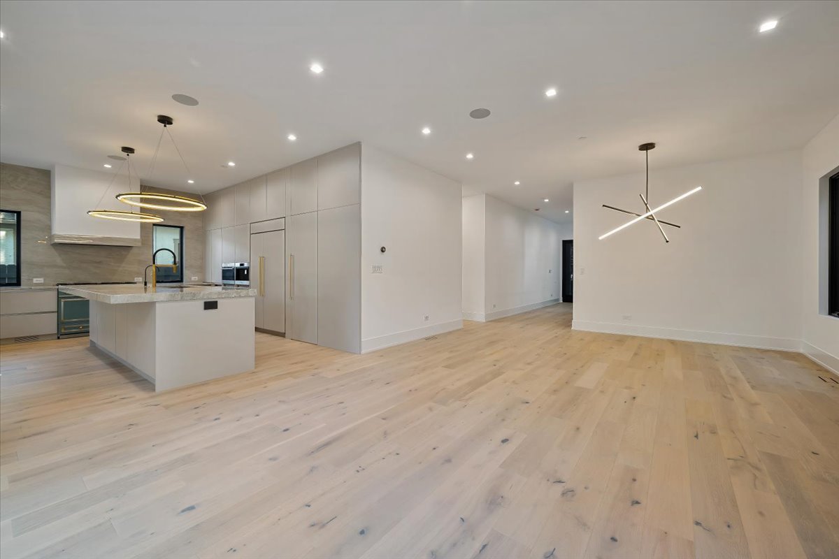 849 Sheridan Road Wilmette, IL 60091 - Photo 22 of 73 a view of a kitchen with kitchen island a sink wooden floor and a refrigerator