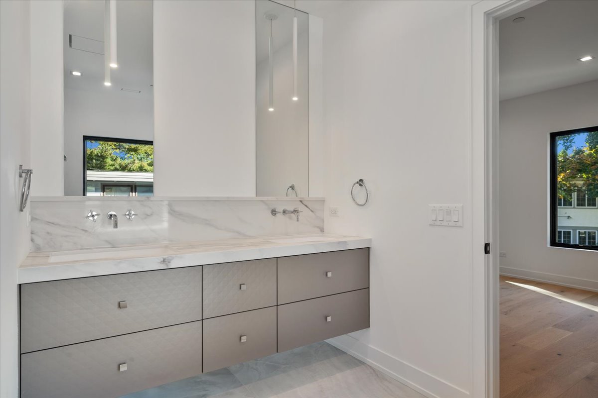 849 Sheridan Road Wilmette, IL 60091 - Photo 34 of 73 a bathroom with a double vanity sink and mirror