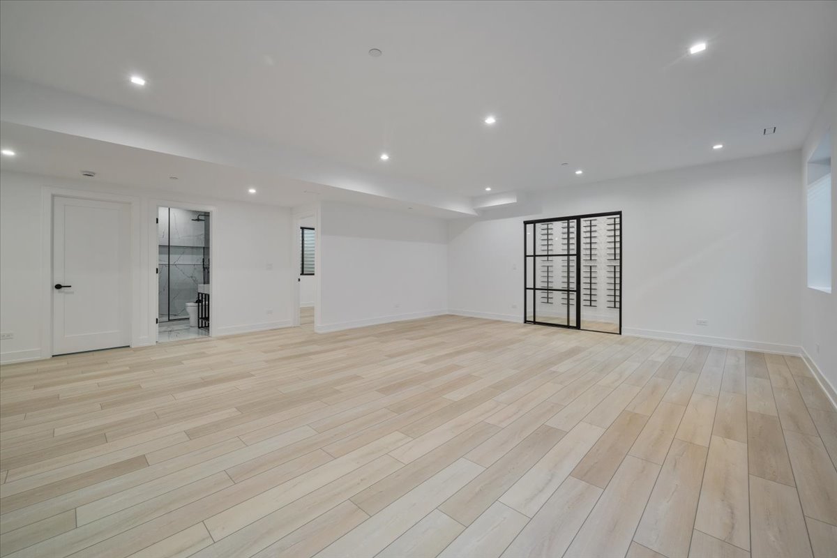849 Sheridan Road Wilmette, IL 60091 - Photo 54 of 73 a view of an empty room with wooden floor and a window