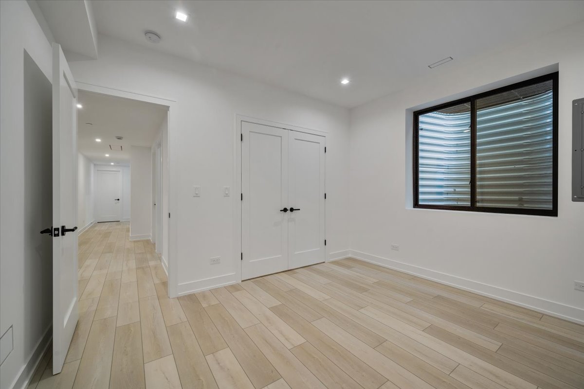849 Sheridan Road Wilmette, IL 60091 - Photo 56 of 73 a view of an empty room with wooden floor and a window