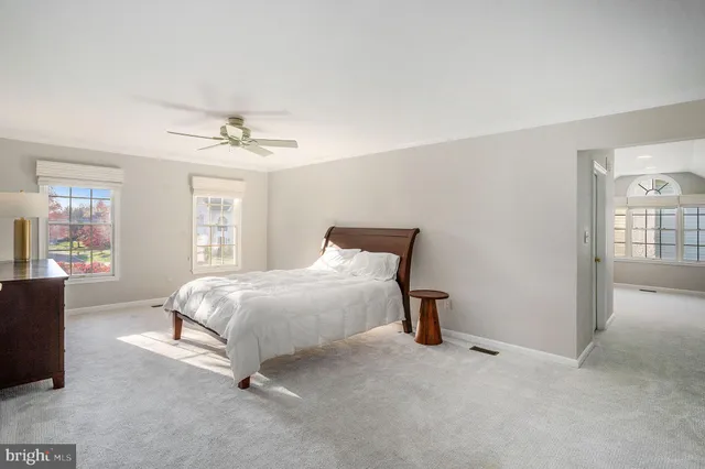 an aerial view of a house with a garden and lake view